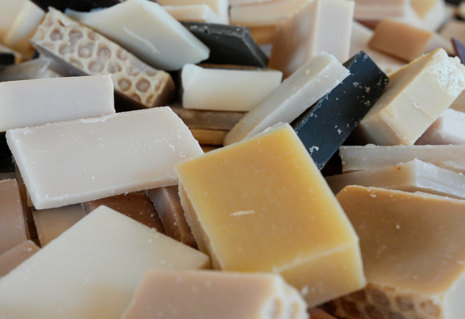 Assorted pieces of soap in various scents and textures.