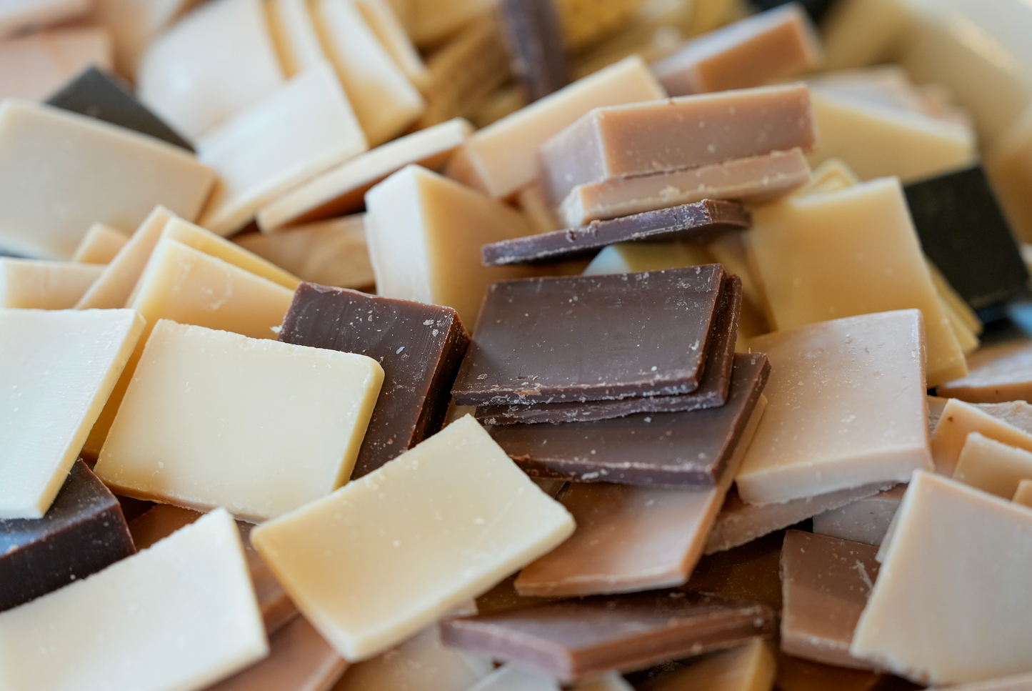 Mixture of bars of soap in various scents including bluebonnet, almond, hemp, matcha mushroom, and others.