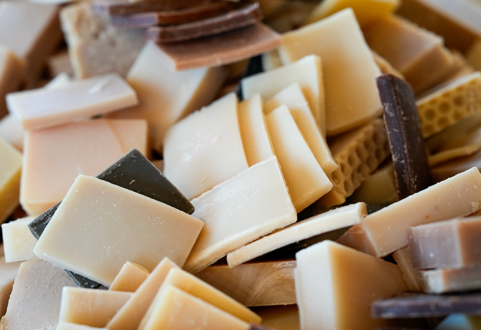 Close-up of assorted bars of soap including honey oatmeal, vanilla, almond, and pumpkin spice
