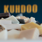 Assorted bars of soap with 'KUHDOO' branding in the background