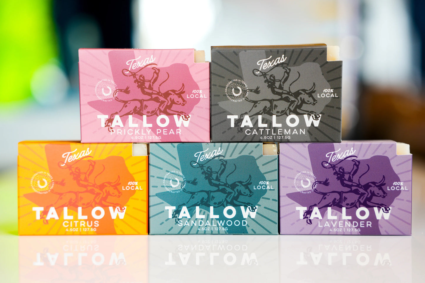 Collection of Tallow products with colorful packaging on a blurred background