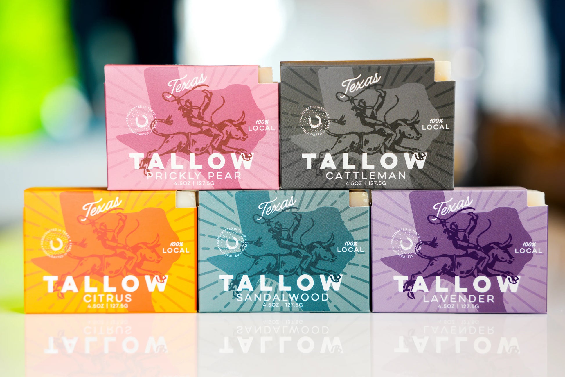 Collection of Tallow products with colorful packaging on a blurred background